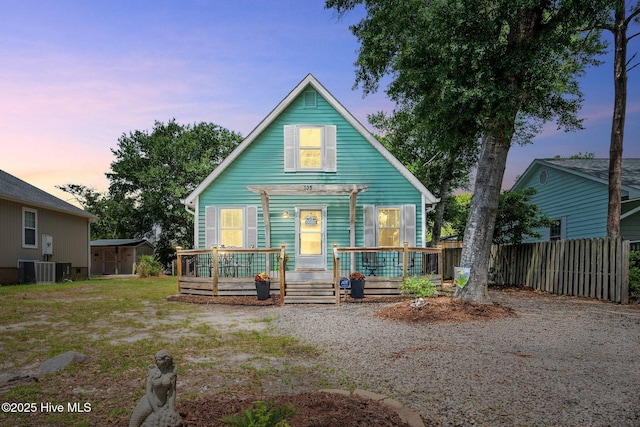 135 NE 34th St, Oak Island, NC 28465 - view of front of house with a shed and a wooden deck