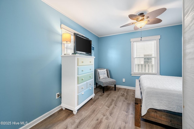 135 NE 34th St, Oak Island, NC 28465 - bedroom with wood finished floors, ornamental molding, and ceiling fan