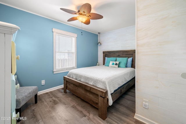 135 NE 34th St, Oak Island, NC 28465 - bedroom with wood finished floors, ornamental molding, and a ceiling fan