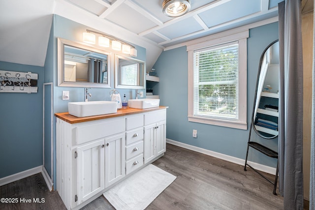 135 NE 34th St, Oak Island, NC 28465 - bathroom featuring double vanity and wood finished floors