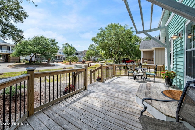 135 NE 34th St, Oak Island, NC 28465 - wooden terrace featuring a residential view and outdoor dining area
