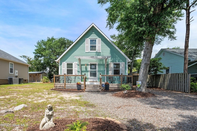 135 NE 34th St, Oak Island, NC 28465 - view of front of house with a shed and a wooden deck