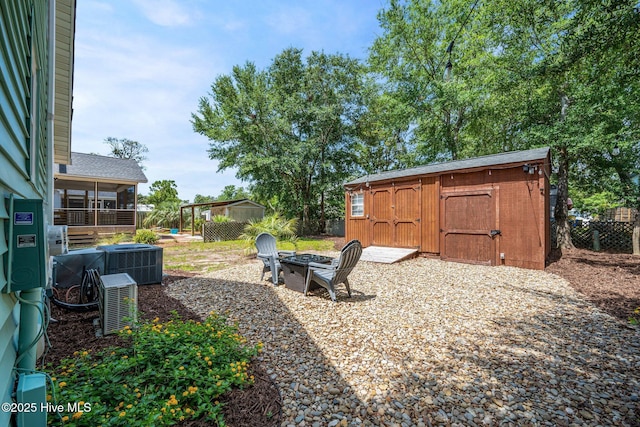 135 NE 34th St, Oak Island, NC 28465 - view of yard featuring a shed, an outdoor fire pit, and a sunroom