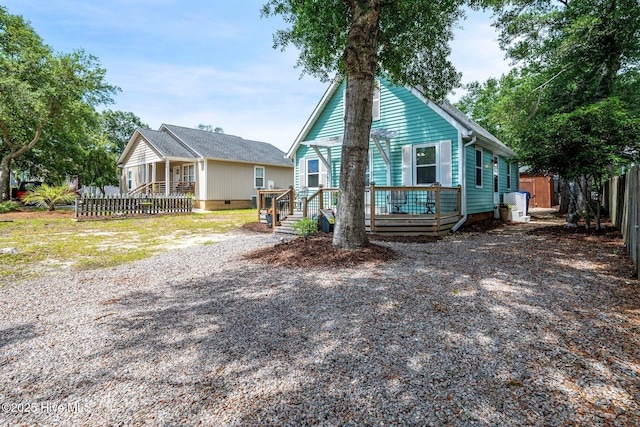 135 NE 34th St, Oak Island, NC 28465 - view of front facade with a deck