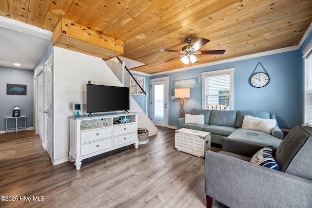 135 NE 34th St, Oak Island, NC 28465 - living area with wood finished floors, a ceiling fan, stairway, wooden ceiling, and crown molding