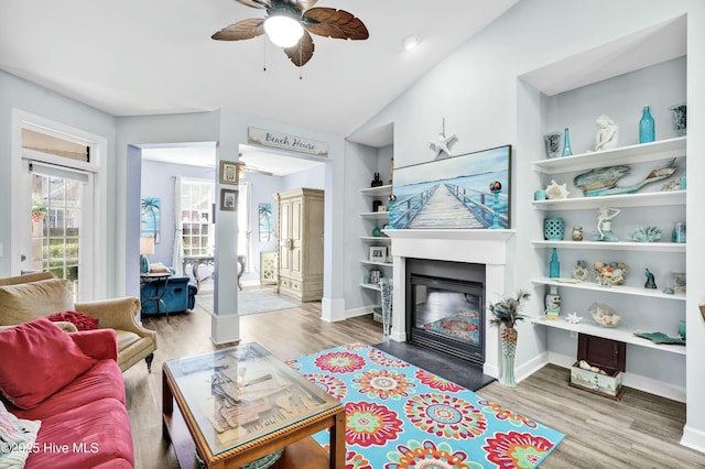 1335 Arbor Ridge Way, Leland, NC 28451 - living room with ceiling fan, wood finished floors, a glass covered fireplace, baseboards, and vaulted ceiling