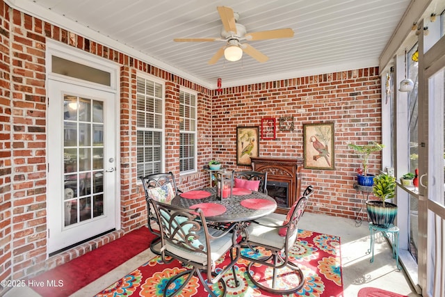 1335 Arbor Ridge Way, Leland, NC 28451 - sunroom / solarium featuring outdoor dining area, ceiling fan, and a fireplace