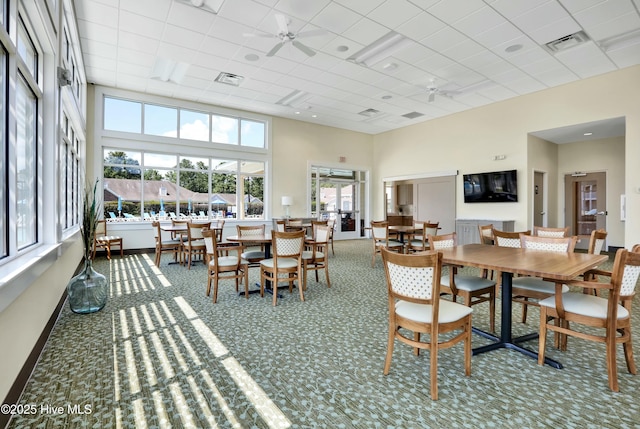 1335 Arbor Ridge Way, Leland, NC 28451 - dining room with plenty of natural light, carpet, a drop ceiling, a ceiling fan, and a towering ceiling