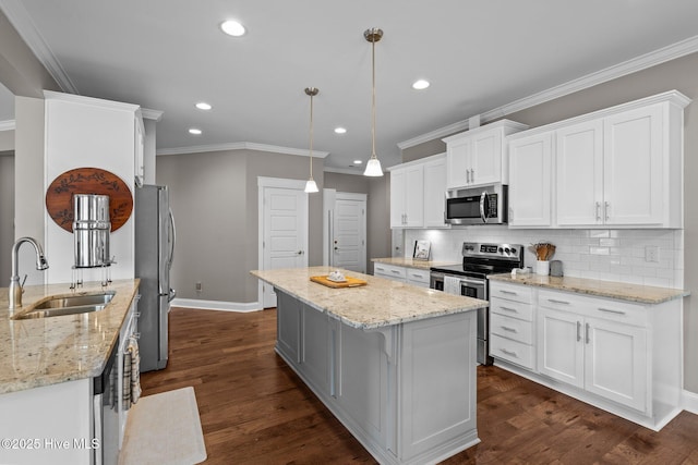 264 Bibey Rd, Carthage, NC 28327 - kitchen with stainless steel appliances, a sink, white cabinets, a kitchen island, and baseboards