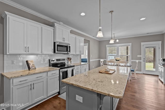 264 Bibey Rd, Carthage, NC 28327 - kitchen with appliances with stainless steel finishes, a kitchen island, white cabinets, decorative backsplash, and ornamental molding