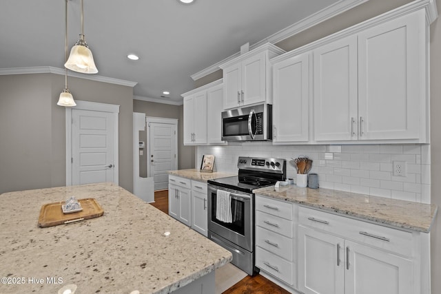 264 Bibey Rd, Carthage, NC 28327 - kitchen with appliances with stainless steel finishes, recessed lighting, white cabinets, ornamental molding, and backsplash