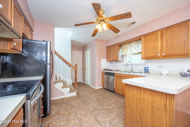 134 Kingsway Way, Moyock, NC 27958 - kitchen featuring appliances with stainless steel finishes, a peninsula, a sink, and decorative backsplash