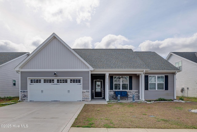 2161 Blue Bonnet Cir, Castle Hayne, NC 28429 - craftsman house with a porch, board and batten siding, an attached garage, concrete driveway, and a front lawn