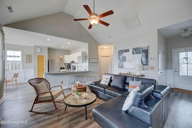 2161 Blue Bonnet Cir, Castle Hayne, NC 28429 - living room with wood finished floors, a wainscoted wall, a ceiling fan, plenty of natural light, and high vaulted ceiling