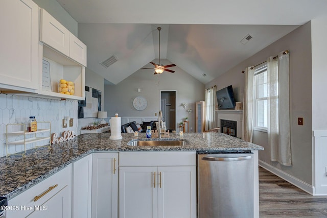 2161 Blue Bonnet Cir, Castle Hayne, NC 28429 - kitchen with stainless steel dishwasher, a sink, a ceiling fan, a peninsula, and white cabinets