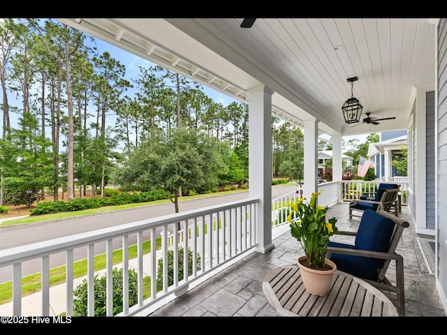1012 Midnight Channel Rd, Wilmington, NC 28403 - porch with a ceiling fan and view of wooded area