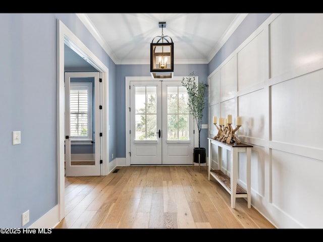1012 Midnight Channel Rd, Wilmington, NC 28403 - entryway featuring french doors, light wood-style floors, crown molding, and baseboards