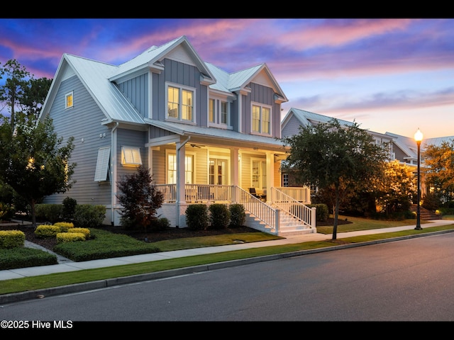 1012 Midnight Channel Rd, Wilmington, NC 28403 - view of front of home featuring covered porch, board and batten siding, metal roof, a standing seam roof, and stairway