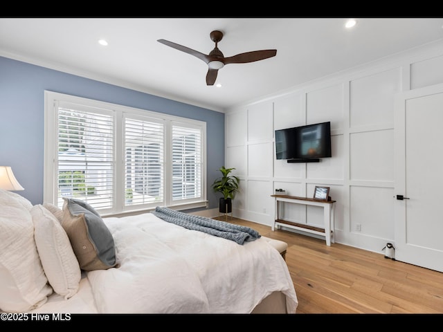 1012 Midnight Channel Rd, Wilmington, NC 28403 - bedroom featuring a decorative wall, light wood-type flooring, crown molding, recessed lighting, and a ceiling fan