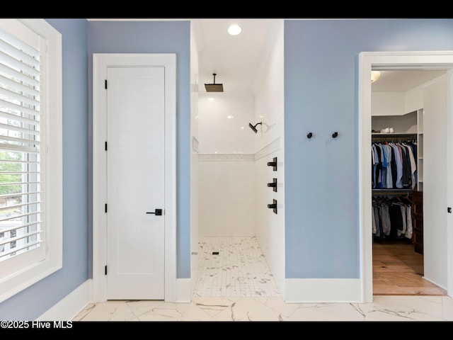 1012 Midnight Channel Rd, Wilmington, NC 28403 - bathroom featuring marble look tiles, a tile shower, baseboards, a walk in closet, and recessed lighting