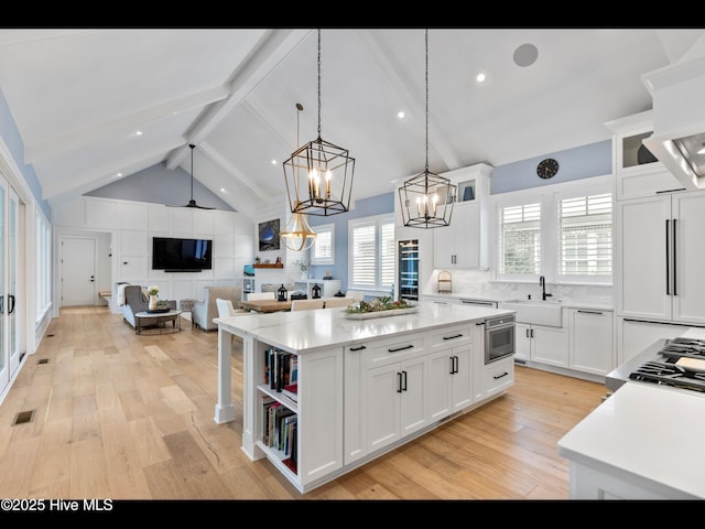 1012 Midnight Channel Rd, Wilmington, NC 28403 - kitchen featuring light wood-style floors, light countertops, a center island, white cabinetry, and recessed lighting