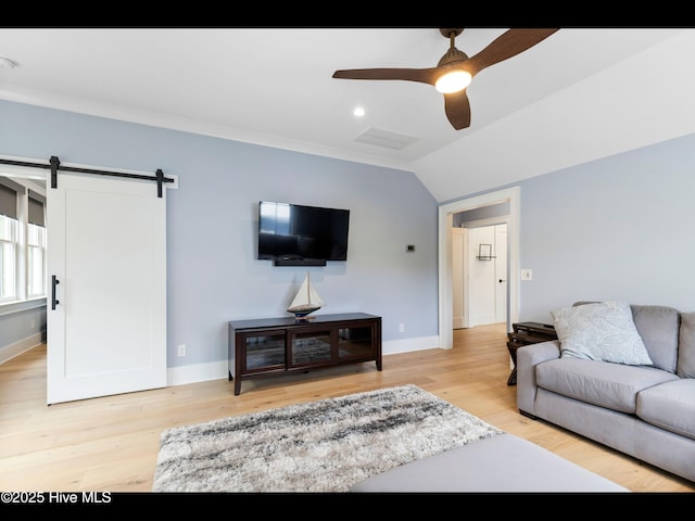 1012 Midnight Channel Rd, Wilmington, NC 28403 - living room featuring ceiling fan, vaulted ceiling, a barn door, baseboards, and wood finished floors