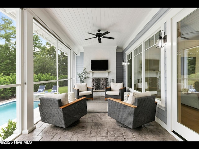1012 Midnight Channel Rd, Wilmington, NC 28403 - sunroom / solarium featuring a ceiling fan and an outdoor living space with a fireplace