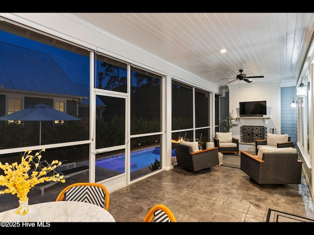 1012 Midnight Channel Rd, Wilmington, NC 28403 - living area featuring a ceiling fan, wood ceiling, a brick fireplace, ornamental molding, and stone finish floors