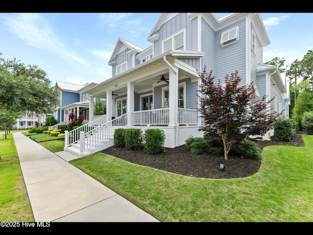 1012 Midnight Channel Rd, Wilmington, NC 28403 - view of side of property with a ceiling fan, covered porch, a lawn, and board and batten siding