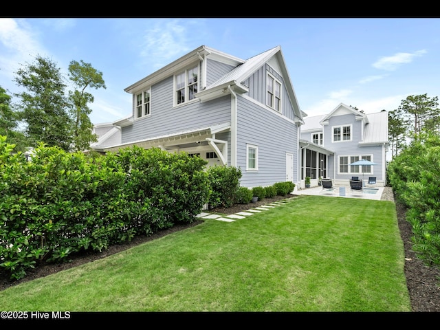 1012 Midnight Channel Rd, Wilmington, NC 28403 - back of property with a patio, a sunroom, and a lawn