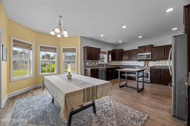 1006 Kingfish Way, New Bern, NC 28562 - dining room featuring plenty of natural light, a chandelier, dark wood-style flooring, baseboards, and recessed lighting