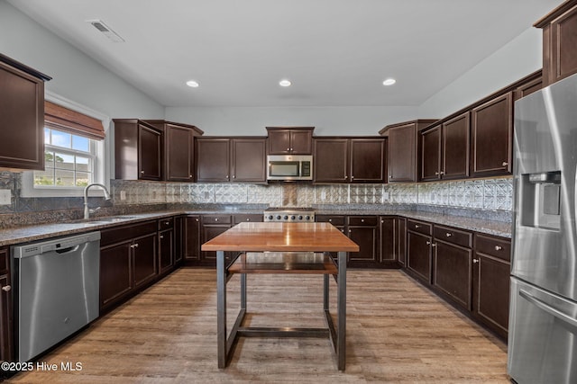 1006 Kingfish Way, New Bern, NC 28562 - kitchen featuring stainless steel appliances, dark brown cabinetry, a sink, backsplash, and recessed lighting
