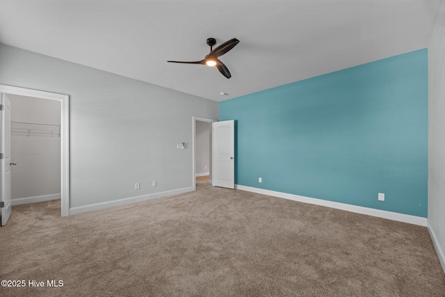 1006 Kingfish Way, New Bern, NC 28562 - unfurnished bedroom with carpet flooring, a walk in closet, and baseboards