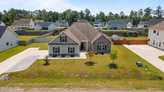 1006 Kingfish Way, New Bern, NC 28562 - view of front facade featuring stone siding, a residential view, and driveway