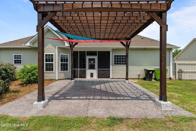 1006 Kingfish Way, New Bern, NC 28562 - back of property featuring a shingled roof, a pergola, a sunroom, and a patio area