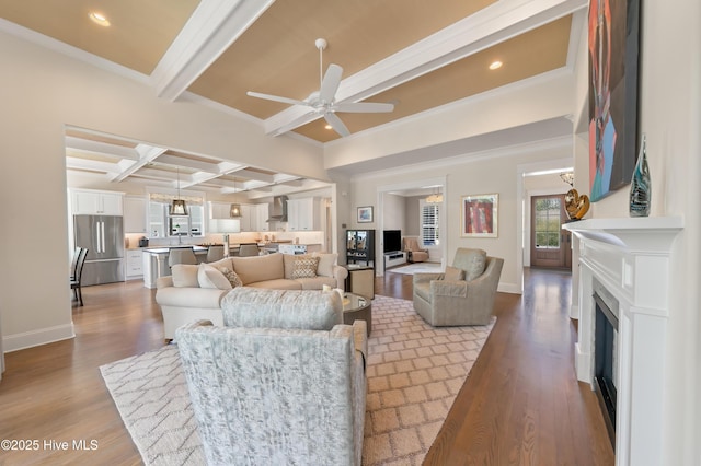 2570 Sugar Maple Ct, Southport, NC 28461 - living area with coffered ceiling, a ceiling fan, wood finished floors, beam ceiling, and a fireplace