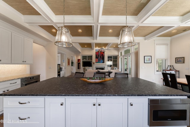 2570 Sugar Maple Ct, Southport, NC 28461 - kitchen with coffered ceiling, white cabinets, open floor plan, a fireplace, and beam ceiling