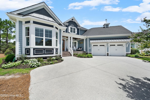 2570 Sugar Maple Ct, Southport, NC 28461 - view of front facade with a porch, an attached garage, a standing seam roof, concrete driveway, and a shingled roof