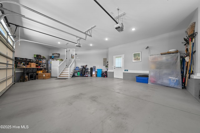 2570 Sugar Maple Ct, Southport, NC 28461 - garage featuring a garage door opener, electric panel, recessed lighting, and freestanding refrigerator
