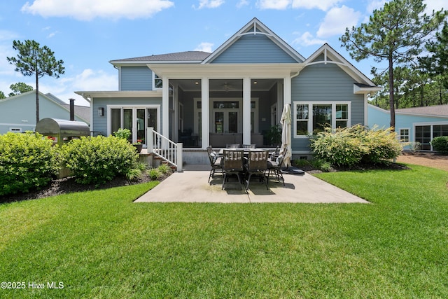 2570 Sugar Maple Ct, Southport, NC 28461 - back of house featuring a sunroom, a patio, and a lawn