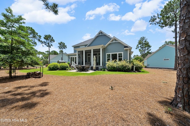 2570 Sugar Maple Ct, Southport, NC 28461 - rear view of property with a sunroom, a lawn, and a patio area