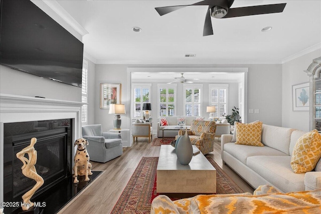 9294 Murphy Way SW, Calabash, NC 28467 - living room featuring ceiling fan, ornamental molding, a glass covered fireplace, light wood-style flooring, and recessed lighting