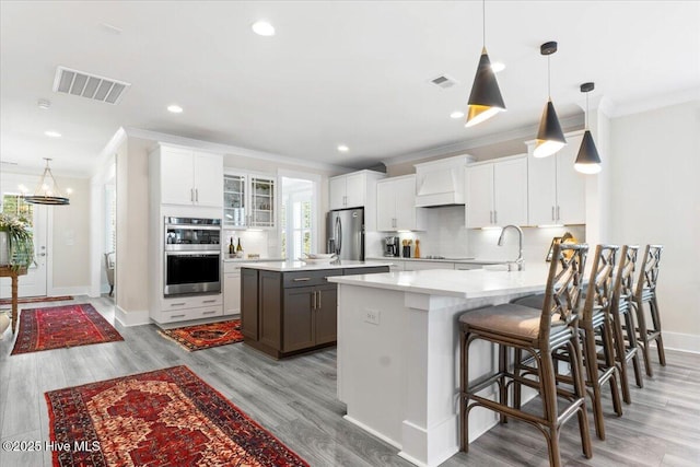 9294 Murphy Way SW, Calabash, NC 28467 - kitchen with appliances with stainless steel finishes, crown molding, a peninsula, light countertops, and tasteful backsplash