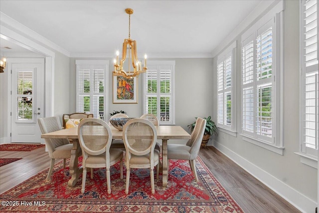 9294 Murphy Way SW, Calabash, NC 28467 - dining area featuring a chandelier, baseboards, wood finished floors, and ornamental molding