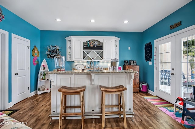 2911 Ridge Rd NW, Wilson, NC 27896 - indoor wet bar with french doors, dark wood finished floors, baseboards, and recessed lighting
