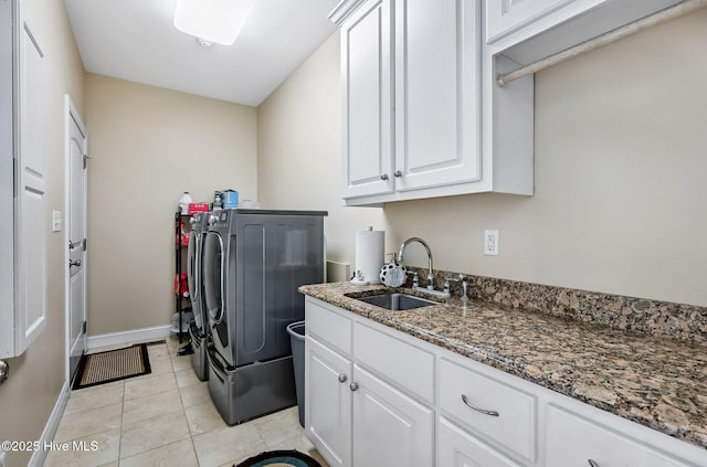 2911 Ridge Rd NW, Wilson, NC 27896 - laundry area with washer and dryer, cabinet space, light tile patterned floors, and baseboards