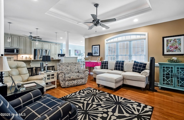 2911 Ridge Rd NW, Wilson, NC 27896 - living room with wood finished floors, a raised ceiling, crown molding, a ceiling fan, and recessed lighting