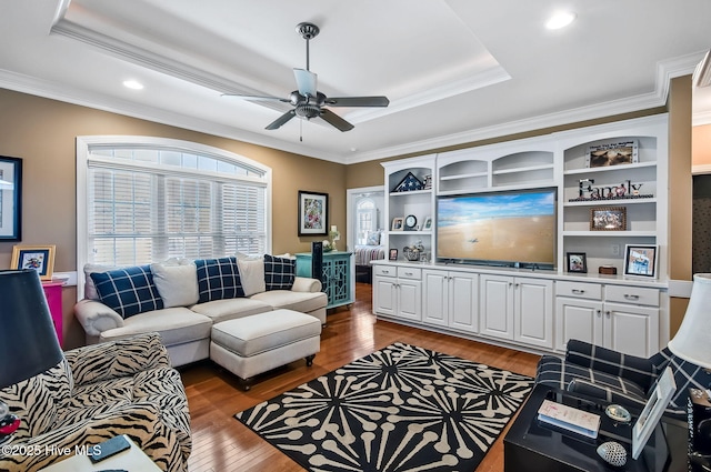 2911 Ridge Rd NW, Wilson, NC 27896 - living area with wood finished floors, ornamental molding, a raised ceiling, ceiling fan, and recessed lighting