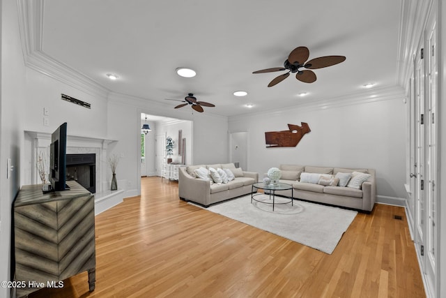 103 Low Country Ct, Hampstead, NC 28443 - living room with ceiling fan, ornamental molding, light wood-style flooring, a premium fireplace, and baseboards