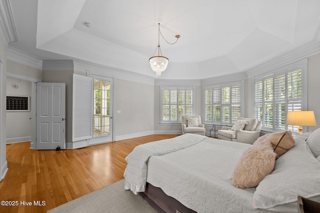103 Low Country Ct, Hampstead, NC 28443 - bedroom with a raised ceiling, light wood-style floors, baseboards, ornamental molding, and a chandelier